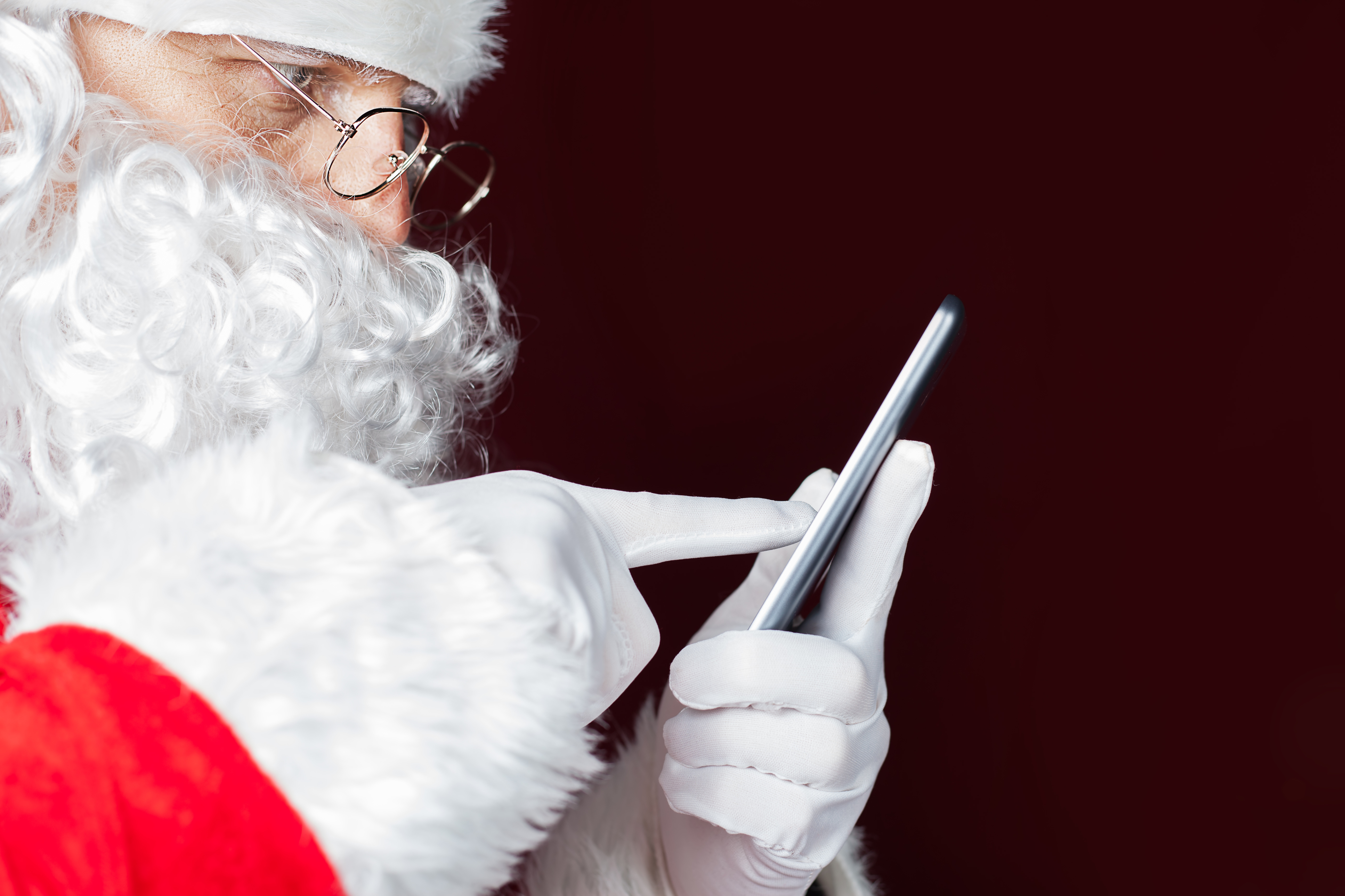 Santa Claus using a mobile phone at Christmas time
